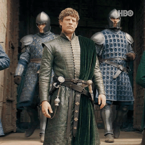 A Man In A Green Coat Is Standing In Front Of A Group Of Soldiers With Hbo Written On The Bottom Right GIF