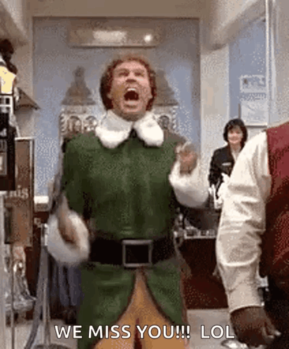 A Man In A Green Elf Costume Is Screaming While Standing In A Room . GIF