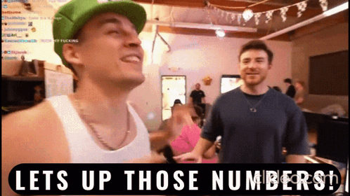A Man In A Green Hat Is Standing Next To Another Man With The Words Lets Up Those Numbers On The Bottom GIF