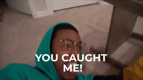 A Man In A Green Hoodie Is Laying On The Floor With The Words You Caught Me Above Him GIF