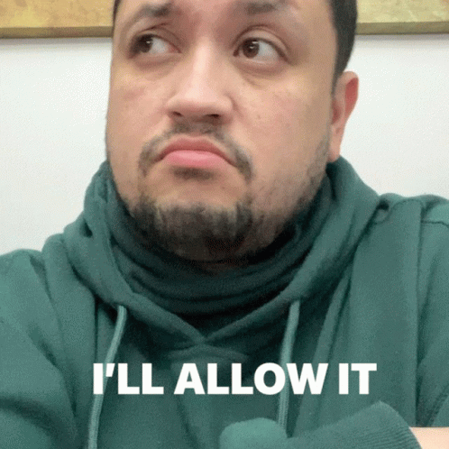 A Man In A Green Hoodie Says " I 'Ll Allow It " In White Letters GIF