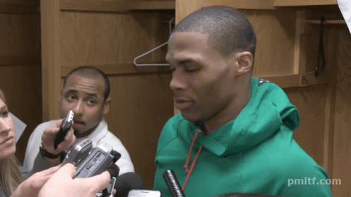 a man in a green jacket is being interviewed