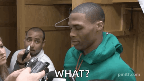 a man in a green jacket is being interviewed by a woman and says what