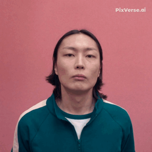 A Man In A Green Jacket Is Smiling In Front Of A Pink Background With Pixverse.ai Written On It GIF