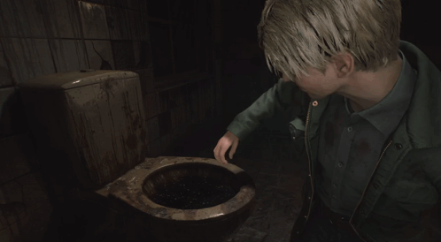 A Man In A Green Jacket Laying On The Ground GIF