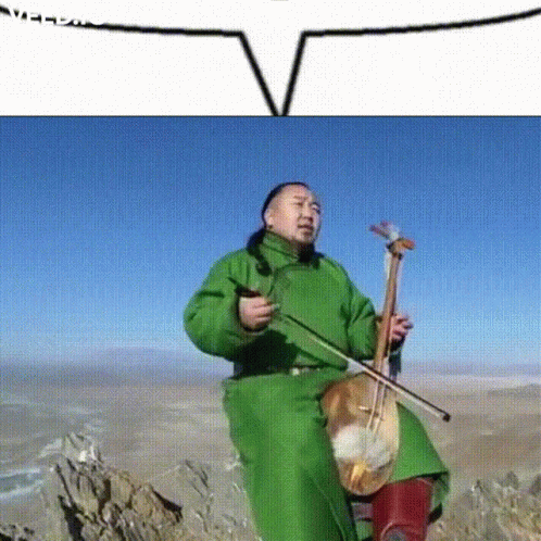 A Man In A Green Jacket Playing A Violin GIF
