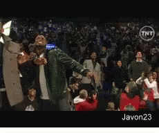 A Man In A Green Jacket Stands In Front Of A Crowd With A Tnt Logo On The Bottom GIF