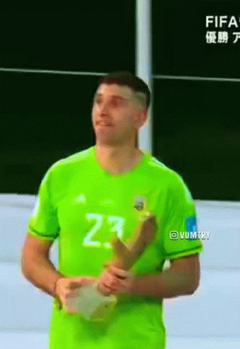 A Man In A Green Jersey With The Number 23 On It Is Holding A Trophy GIF