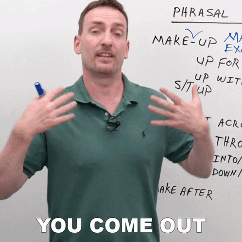 A Man In A Green Polo Shirt Stands In Front Of A Whiteboard That Says Phrasal GIF