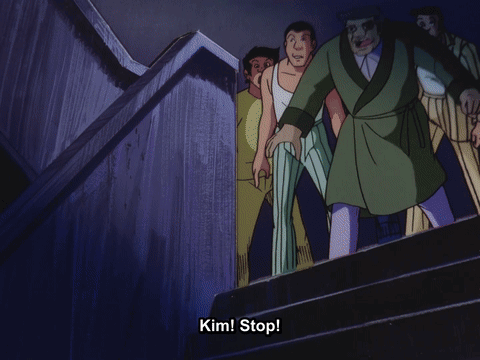 A Man In A Green Robe Is Walking Down Stairs With The Words Kim Stop Behind Him GIF