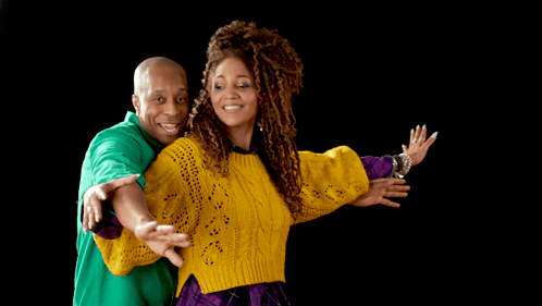 A Man In A Green Shirt And A Woman In A Yellow Sweater Are Posing For A Picture GIF