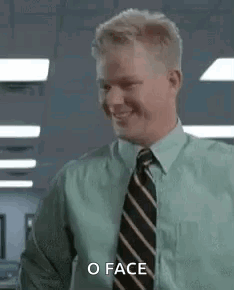 A Man In A Green Shirt And Tie Is Smiling And Saying `` O Face '' . GIF