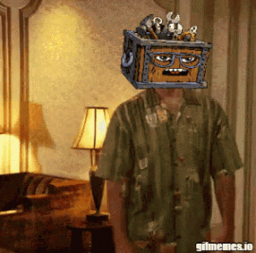 A Man In A Green Shirt Has A Crate On His Head GIF