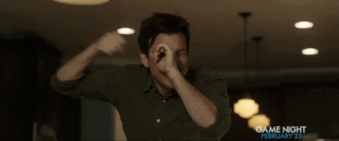 A Man In A Green Shirt Is Covering His Mouth With His Hands In A Game Night Ad GIF
