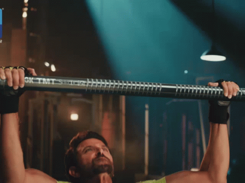A Man In A Green Shirt Is Doing Pull Ups With A Bar That Says Gk Tmt On It GIF
