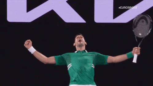 A Man In A Green Shirt Is Holding A Tennis Racket In Front Of A Eurosport Sign GIF