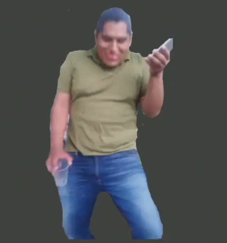 A Man In A Green Shirt Is Holding Two Cell Phones GIF