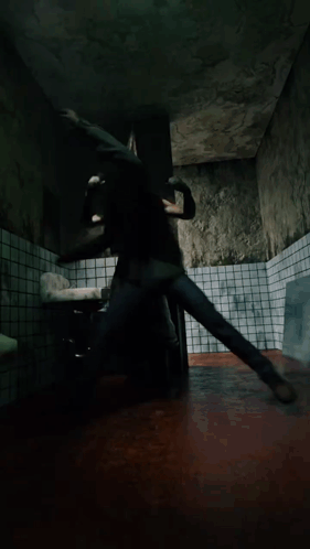 A Man In A Green Shirt Is Laying On The Floor GIF