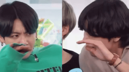 A Man In A Green Shirt Is Making A Funny Face And A Man In A Black Shirt Is Covering His Nose . GIF