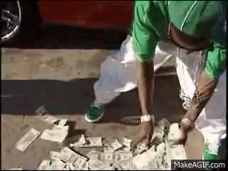 A Man In A Green Shirt Is Standing Next To A Pile Of Money On The Ground . GIF