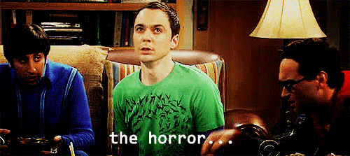 A Man In A Green Shirt Says " The Horror " In Front Of Two Other Men GIF