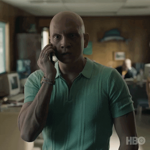 A Man In A Green Shirt Talking On A Cell Phone With Hbo Written On The Bottom GIF