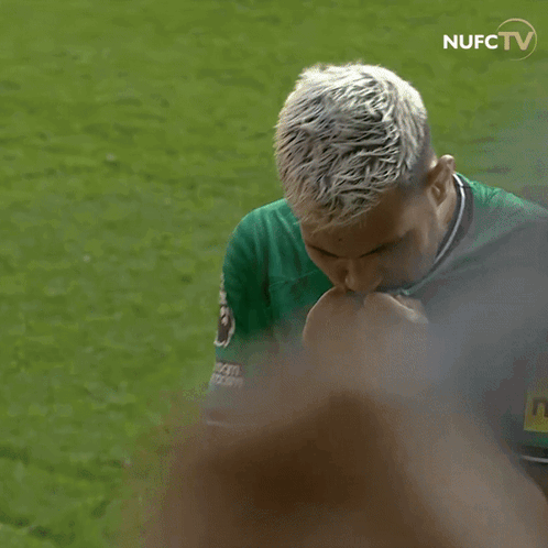 A Man In A Green Shirt With A Yellow Patch That Says Neon GIF