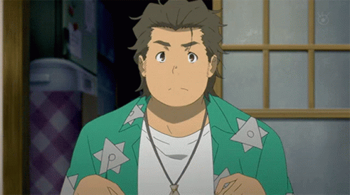 A Man In A Green Shirt With Triangles On It Is Looking At The Camera GIF