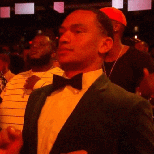 A Man In A Green Suit And Bow Tie GIF