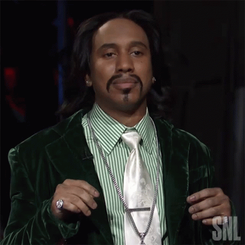 A Man In A Green Suit And Tie With Snl Written On The Bottom GIF