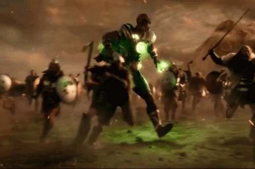 A Man In A Green Suit Is Surrounded By A Group Of Men GIF