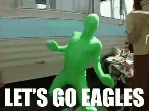 A Man In A Green Suit Says Let 'S Go Eagles In White Letters GIF