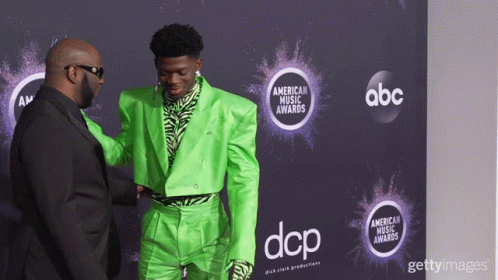A Man In A Green Suit Shakes Hands With A Man In A Black Suit GIF