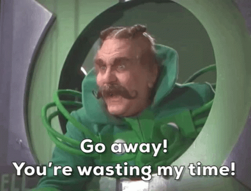 A Man In A Green Suit With A Mustache Says Go Away You 'Re Wasting My Time GIF