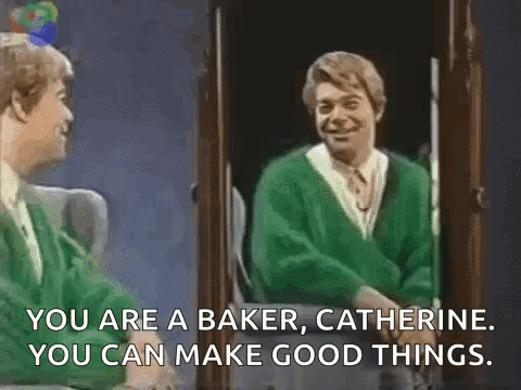 A Man In A Green Sweater Is Standing In Front Of A Mirror And Talking To Another Man . GIF