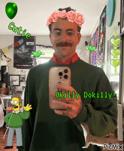 A Man In A Green Sweater Is Taking A Picture Of Himself With A Flower Crown On His Head GIF