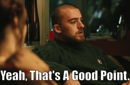 A Man In A Green Sweater Says " Yeah That 'S A Good Point " In Front Of A Woman GIF