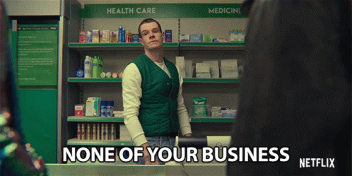 A Man In A Green Vest Is Standing In Front Of A Shelf That Says Health Care GIF
