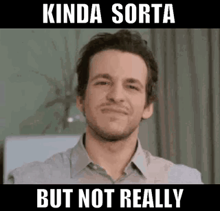 A Man In A Grey Shirt Is Smiling And Making A Funny Face . GIF