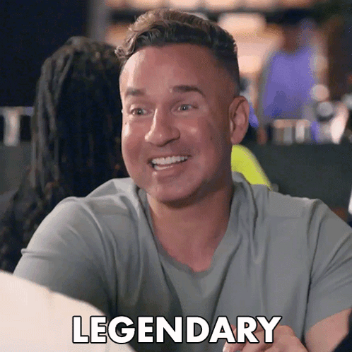 A Man In A Grey Shirt Is Smiling And The Word Legendary Is On The Bottom GIF