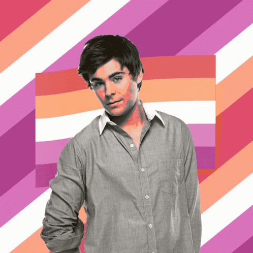 A Man In A Grey Shirt Is Standing In Front Of A Pink And White Striped Background GIF