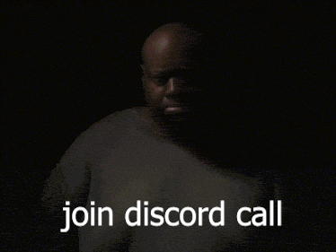 A Man In A Grey Shirt Says Join Discord Call In A Dark Room GIF