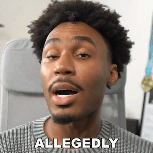 A Man In A Grey Sweater Says Allegedly In Front Of His Face GIF