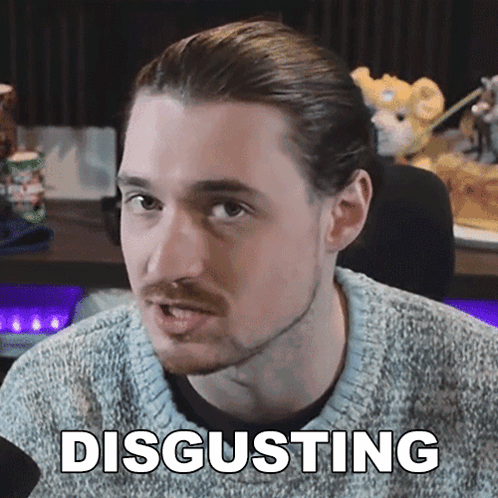 A Man In A Grey Sweater Says Disgusting In White Letters GIF