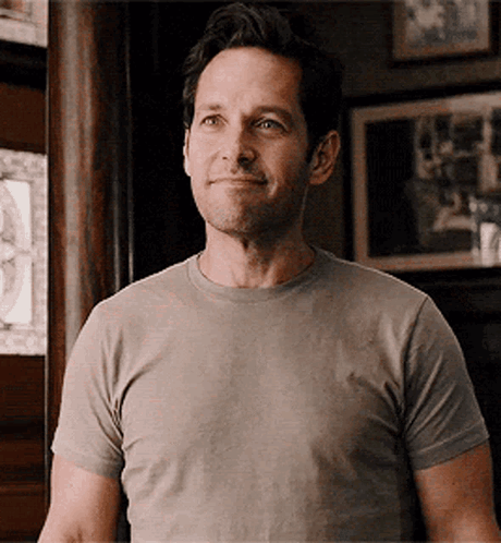 Smiling Man In Grey T-Shirt Looking At Camera GIF