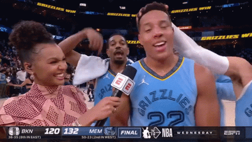 A Man In A Grizzlies Jersey Is Interviewed By A Reporter GIF