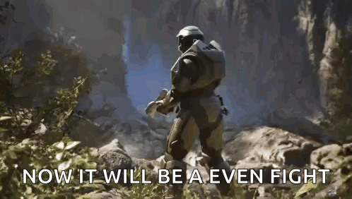A Man In A Halo Armor Is Holding A Blue Object In His Hand . GIF