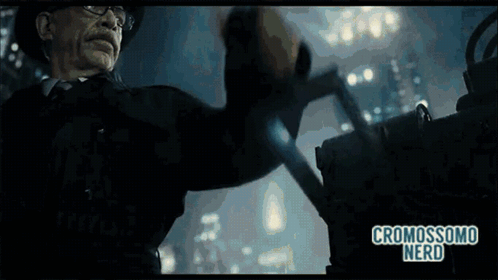 A Man In A Hat And Glasses Is Holding A Gun And The Words Cromosomo Nerd Are On The Bottom Of The Screen GIF