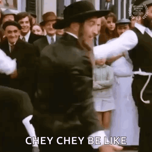 A Man In A Hat Is Dancing In Front Of A Crowd Of People And Saying Chey Chey Be Like . GIF
