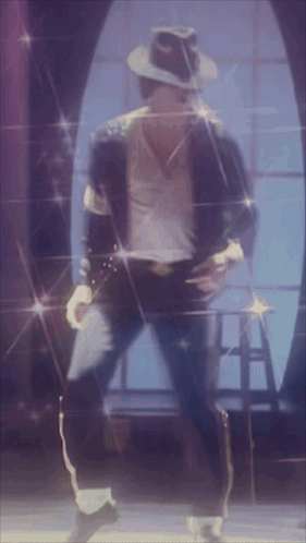 A Man In A Hat Is Dancing On A Stage In Front Of A Window GIF